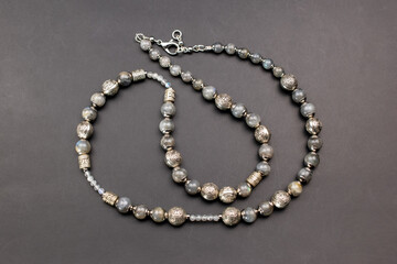 Healing crystals jewelry, gemstone beads necklace on black background, unique handmade jewellery background, promotional photo for an online jewellery store