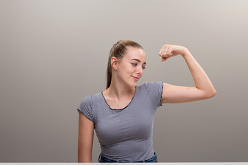 Flexing arm, ironic smile at bicep