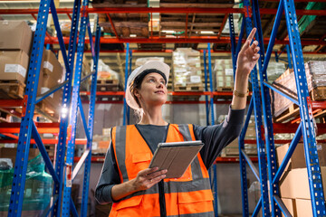 Caucasian young woman industrial worker working in manufacturing plant. 