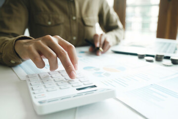 Fototapeta premium Accountant using calculator for calculate finance report in office 