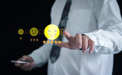 Man's hands choosing on the happy Smile face icon to give satisfaction in service for feedback...