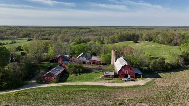 Aerial Virginia farm red barn silo grain elevator landscape slid. Rural community Spotsylvania County, Virginia, near Fredericksburg. Battle grounds of American Civil War. Agriculture, meadows, farms.