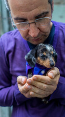 a man in a purple shirt with his pet dogs