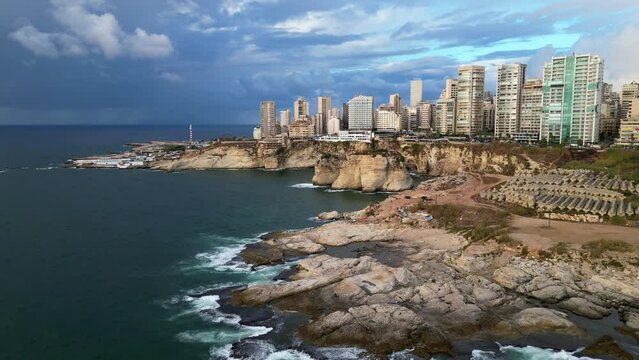 Wide angle establishing drone shot Raouche rocks and coast in Beirut