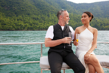 couple drinking and looking each other in luxury yacht