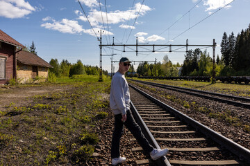 Skelleftea, Sweden A young man stands on the railroad tracks in northern Sweden.