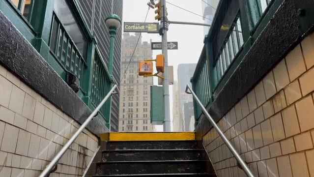 Idyllic view of dilapidated subway entrance in New York City, USA during rainy day. Slow motion.