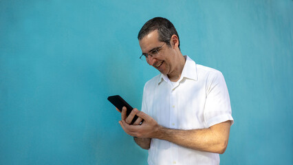 a man accessing his smartphone and happy