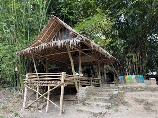 Fototapeta na wymiar And old and vintage hut made from bamboo tree and straw in bamboo forest