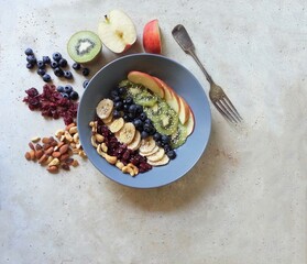 healthy food made with fresh fruit and nuts in bowl on stone table