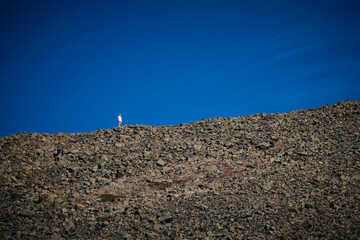 Person standing on rock formation under big blue sky. Freedom. Solo. Colorado. United States of America