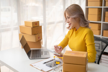 Portrait of Starting small businesses SME owners female entrepreneurs working on receipt box and check online orders to prepare to pack the boxes, sell to customers, SME business ideas online.