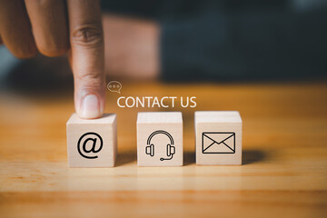 Website page contact us or e-mail marketing concept. Customer support hotline connects people. Wood...
