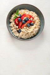 Healthy homemade oatmeal with berries for breakfast.