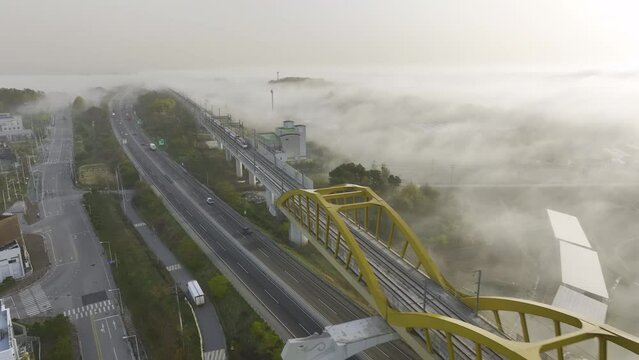A passenger train is passing by the morning misty railroad. 아침, 안개, 열차