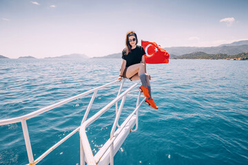 Happy and beauty girl on a luxury yacht with turkish flag
