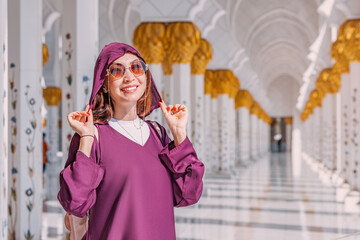 The grandeur of Sheikh Zayed Grand Mosque is amplified by the sight of a tourist girl in Abaya...