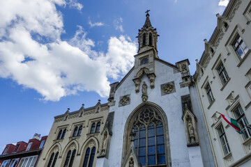 cathedral with lot of windows and a high tower with blue sky in hungary