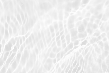 Fototapeta na wymiar White water with ripples on the surface. Defocus blurred transparent white colored clear calm water surface texture with splashes and bubbles. Water waves with shining pattern texture background.