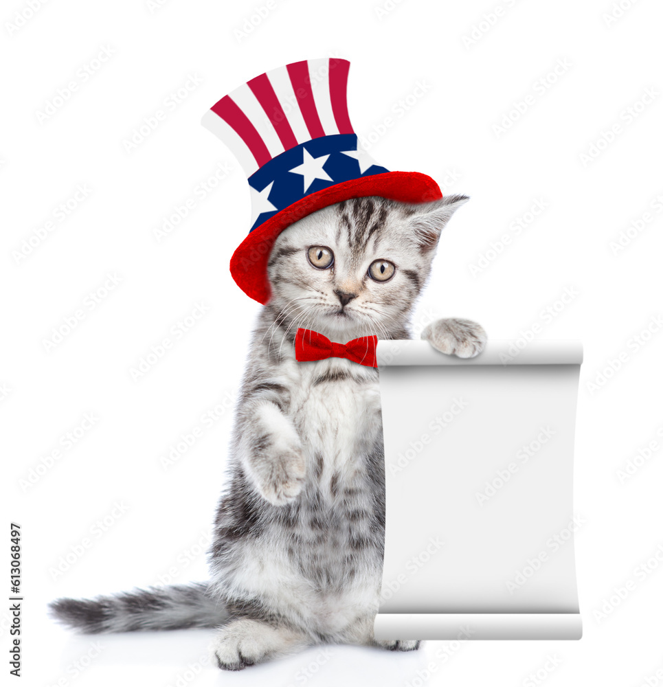 Poster Cute kitten wearing like Uncle Sam looks at camera and shows empty list. isolated on white background