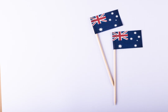 Overhead view of small australian flags over white background, copy space
