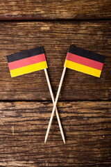 Overhead view of german national flag over wooden table, copy space