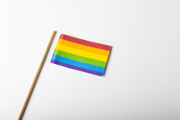 High angle view of rainbow flag with stick isolated on white background, copy space