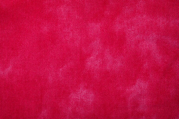 赤いムラ染めの布地の背景テクスチャー