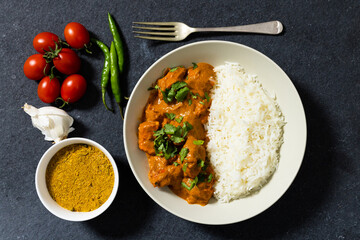 Directly above shot of rice with meat gravy served in bowl by tomatoes, chilies, garlic and spices