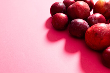 High angle view of fresh peaches against pink background, copy space