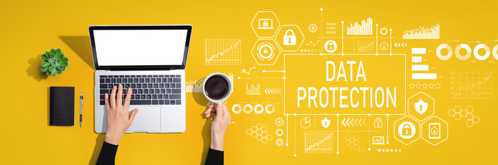 Data protection theme with person using a laptop computer