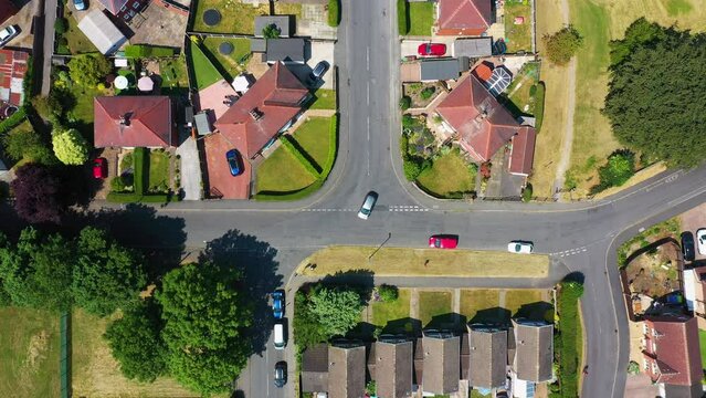 Straight down aerial footage of the beautiful small British town of Hemsworth in the City of Wakefield, West Yorkshire, England showing the housing estates and road junction in the summer