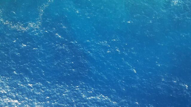 Full frame of crystal sea surface with deep blue water, Aerial top down view