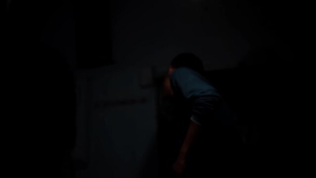 Intense Shot of the victim punching the gangster on the face in a mysterious room with dark lights HD footage in 24FPS.
