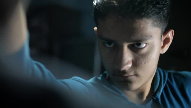 Dolly shot of a teenage boy facing a hostage and asking for money, HD footage. 24FPS.