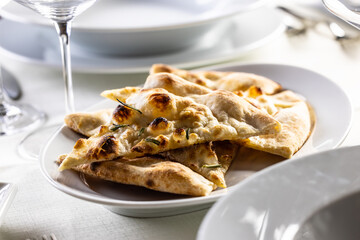 Italian dry pizza dough baked and sliced as a crunchy side dish in a restaurant