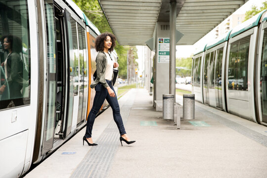 Young confident and relaxed woman commuting in city tram.