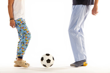 Father and son in pajama playing football. Legs. Night wear