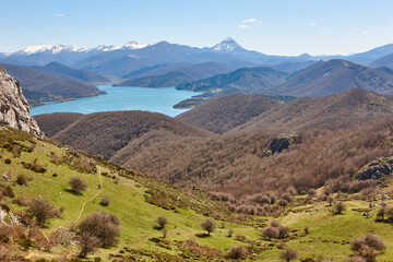 Picturesque reservoir and mountain landscape in Riano. Trekking. Spain