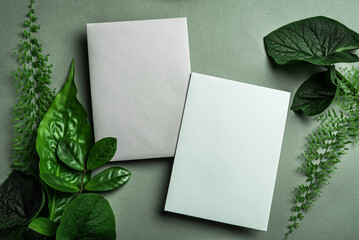 Blank greeting cards and green leaves