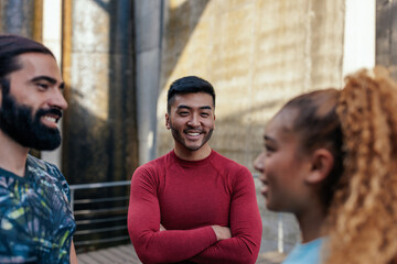 Fototapeta premium Happy multiracial young people in sports clothes socializing