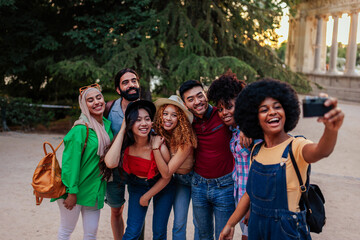 Fototapeta premium Big group of happy friends stands on city street and taking selfie