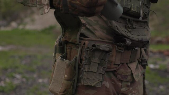 Closeup of Ukrainian soldier holding grenade