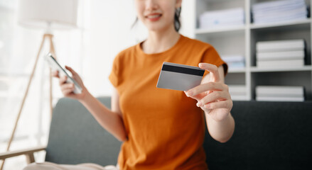 Asian woman hands using smartphone and holding credit card sitting. Online Shopping payments concept.
