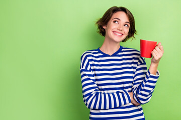 Photo of optimistic positive cute woman with bob hairstyle sailor shirt hold mug look empty space...
