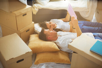 High view of happy couple lying on floor with a lot of boxes - 613088229