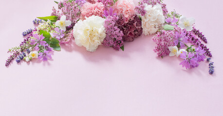 beautiful summer flowers on pink paper background