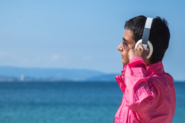 relaxed young man with headphones outside