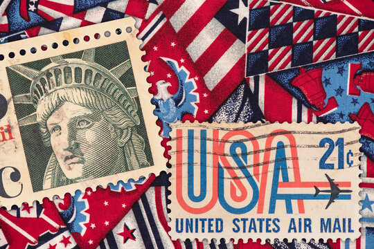 Old united states and statue of liberty stamps on fabric background with american symbol print background.