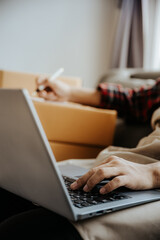 Entrepreneurs Small Business SME Independent men work at home Use smartphones and laptops for commercial checking, online marketing, packing boxes, SME sellers, concept, e-commerce team, online sales